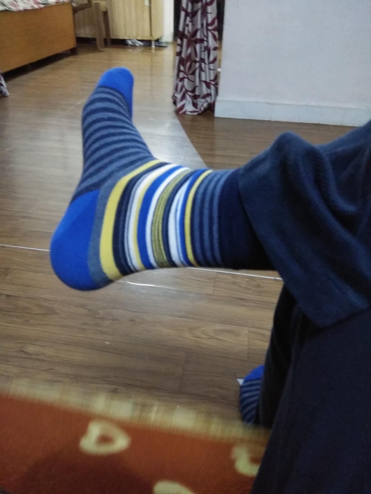 Customer wearing Jumplings blue striped socks at home