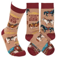 This pair of colorful socks displays a unique hand illustrated designs of various horses with saddles with a fun sentiment that reads "I'd Rather Be At The Barn." Socks feature a one size fits most design made with cotton, nylon, and spandex. A fun western-themed gift perfect for everyday self-expression.