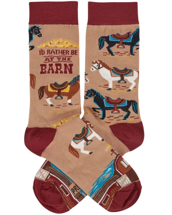 This pair of colorful socks displays a unique hand illustrated designs of various horses with saddles with a fun sentiment that reads "I'd Rather Be At The Barn." Socks feature a one size fits most design made with cotton, nylon, and spandex. A fun western-themed gift perfect for everyday self-expression.