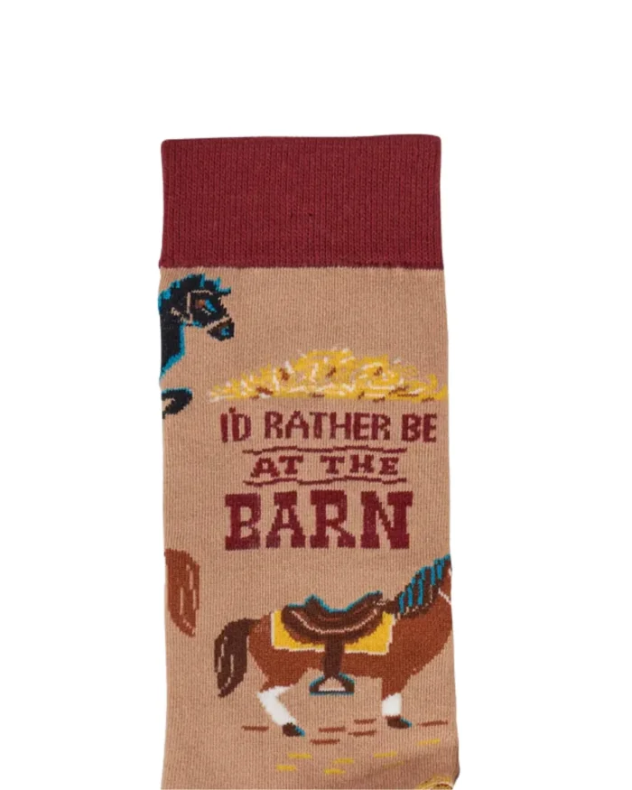 This pair of colorful socks displays a unique hand illustrated designs of various horses with saddles with a fun sentiment that reads "I'd Rather Be At The Barn." Socks feature a one size fits most design made with cotton, nylon, and spandex. A fun western-themed gift perfect for everyday self-expression.